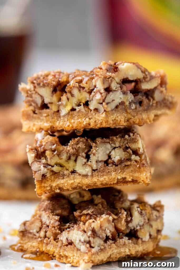 Stack of healthy pecan pie bars with maple drizzle
