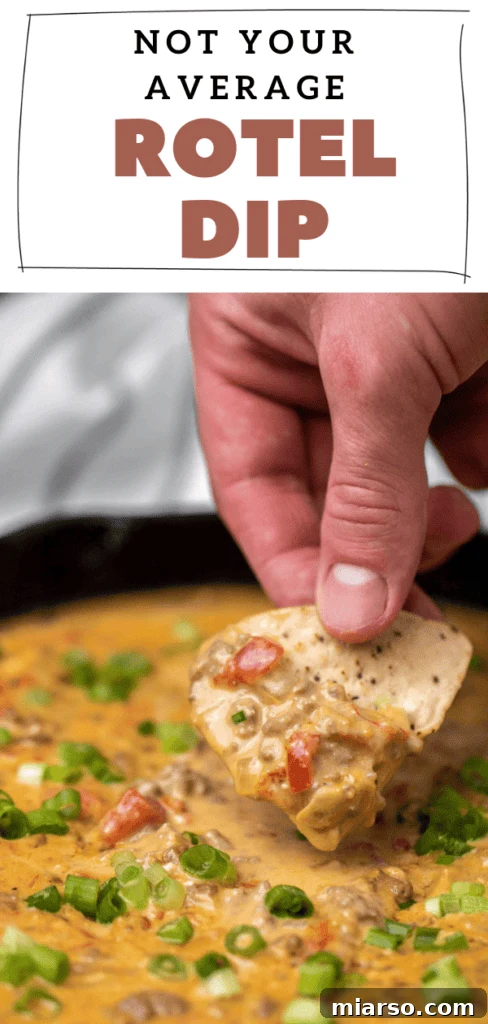 Easy cheese rotel dip in a white bowl with green onions and tortilla chips, perfect for a party.