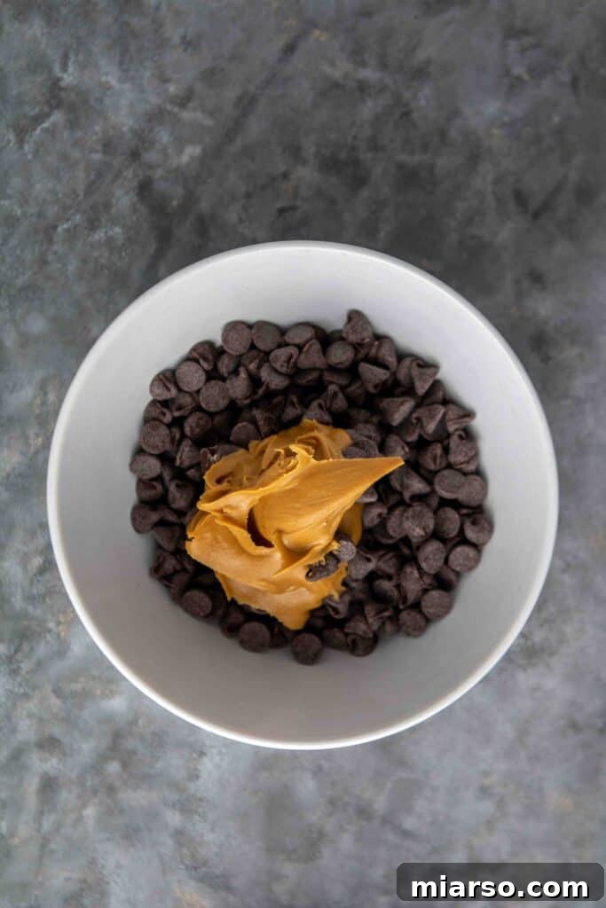 No-Bake Chocolate Peanut Butter Crispy Bars 11 Melted chocolate and peanut butter in a bowl for the topping