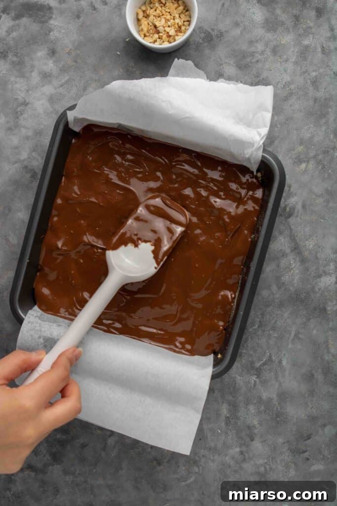 No-Bake Chocolate Peanut Butter Crispy Bars 13 Hand topping rice krispie treats with melted chocolate and peanut butter