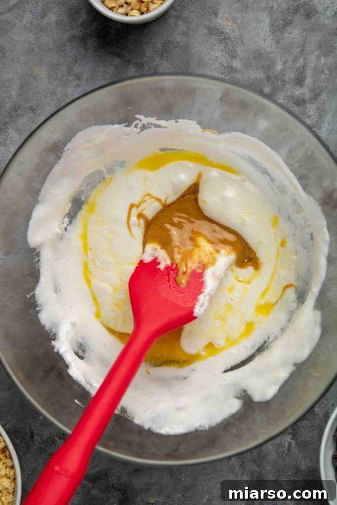 No-Bake Chocolate Peanut Butter Crispy Bars 6 Melted marshmallows with butter and peanut butter in a bowl