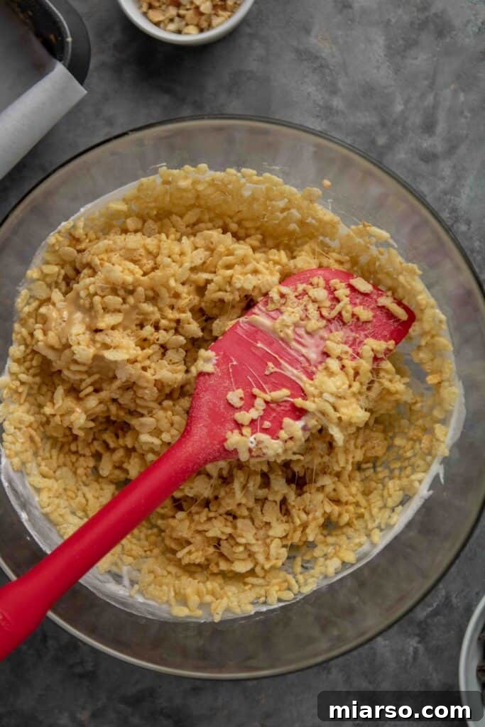 No-Bake Chocolate Peanut Butter Crispy Bars 8 Rice krispie cereal being folded into the wet ingredients