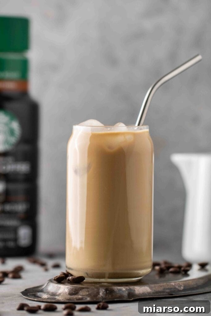 Starbucks Velvety Vanilla Cold Brew 7 Starbucks copycat sweet cream cold brew coffee in a tall glass, garnished with a straw.