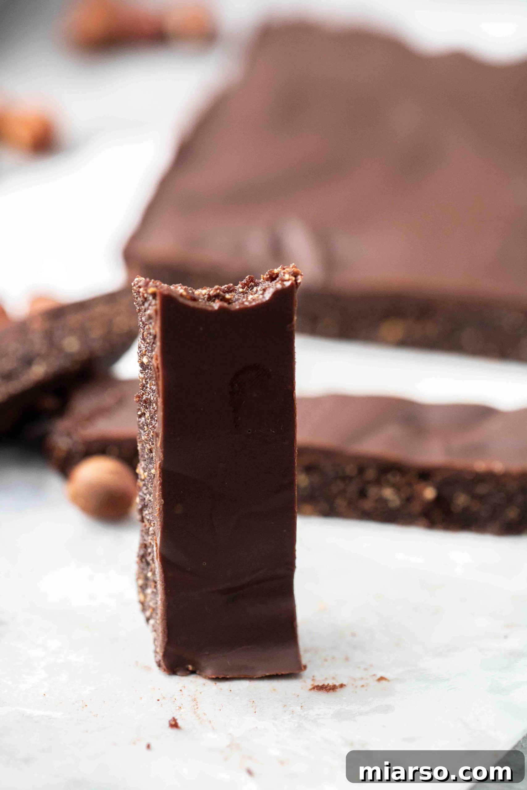 Close-up of a delicious vegan chocolate hazelnut bite, showing the rich layers.