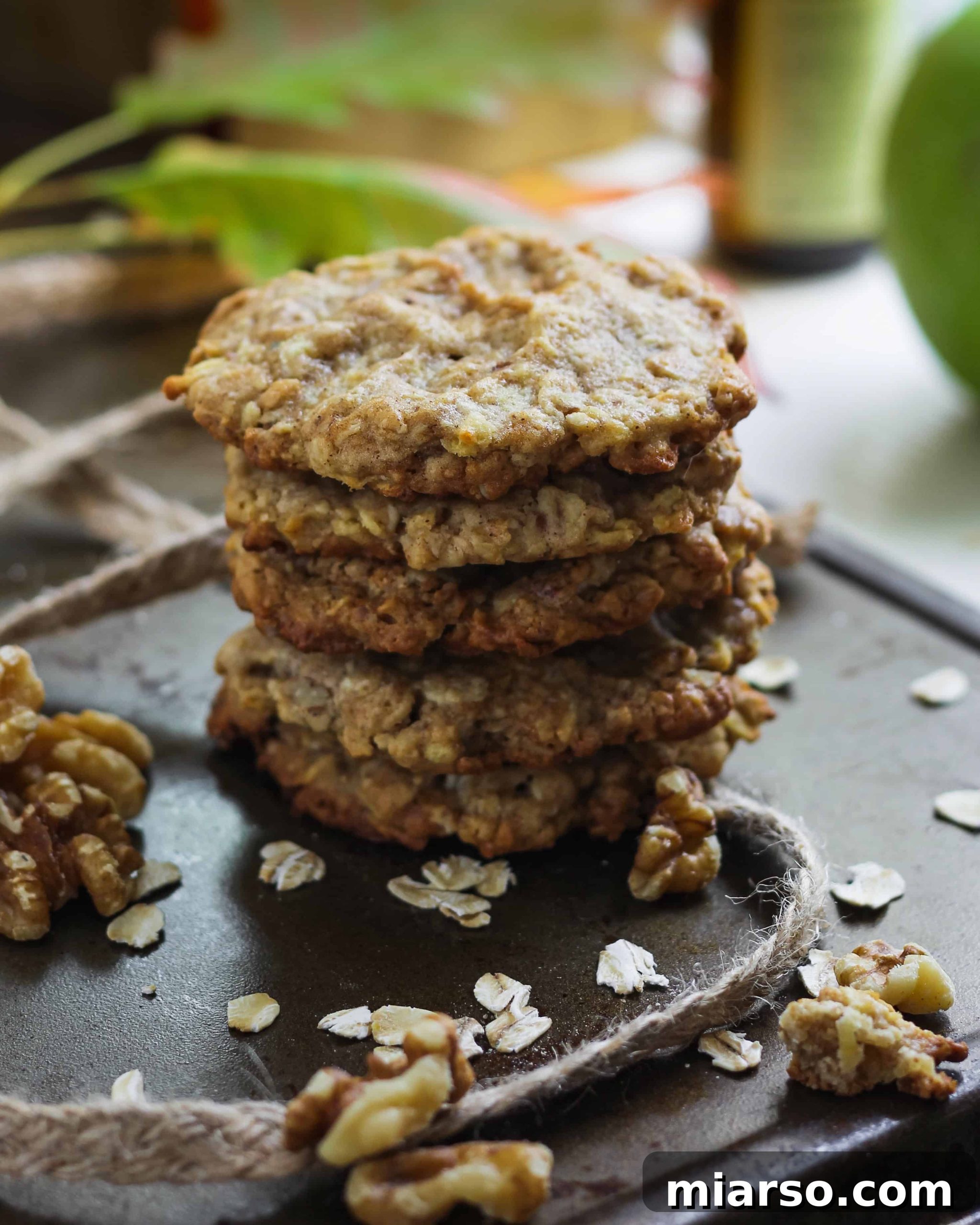 Cozy Apple Cinnamon Oat Cookies 5 Close-up of a stack of freshly baked Apple Cinnamon Oatmeal Cookies, garnished with a sprinkle of cinnamon, ready to be enjoyed.
