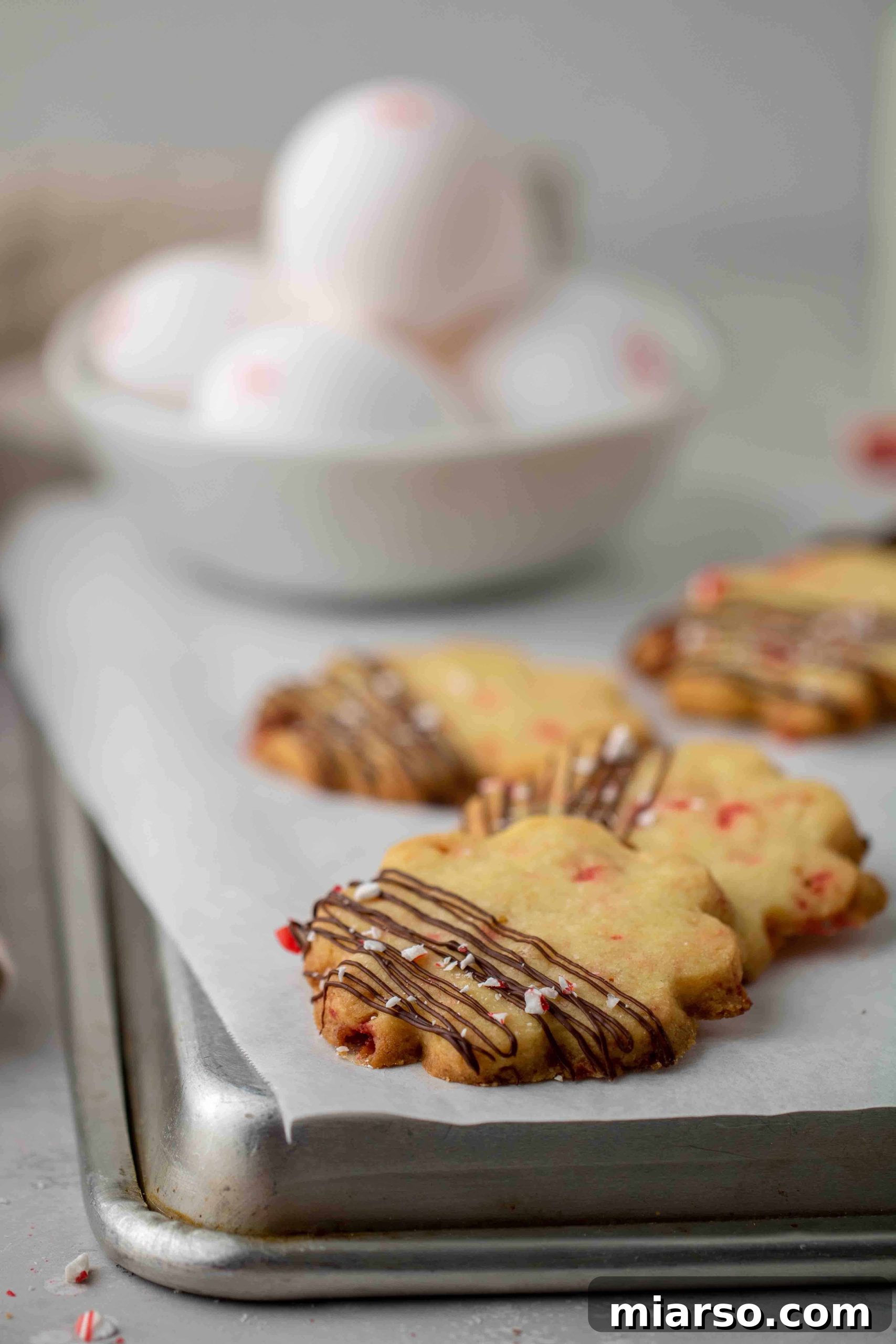 Close-up shot of the tender, crumbly texture of a peppermint shortbread cookie, showcasing the quality of the dough made with egg yolk.