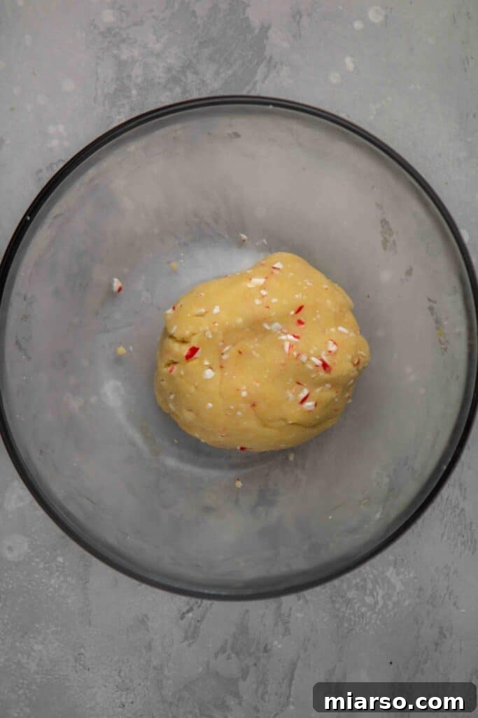 Image showing egg yolk being added to the shortbread dough mixture.