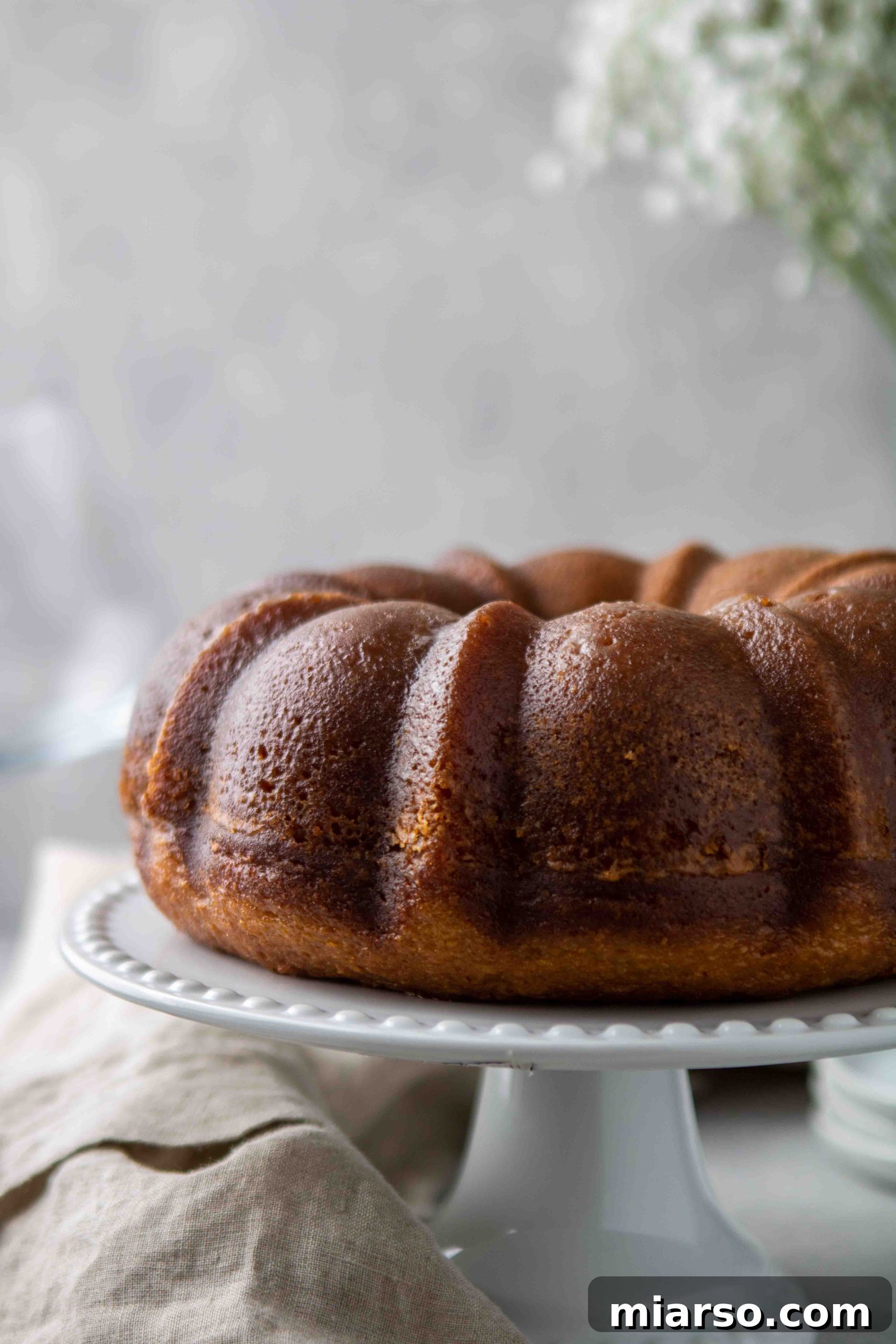 Full bundt cake with white wine syrup, ready to serve