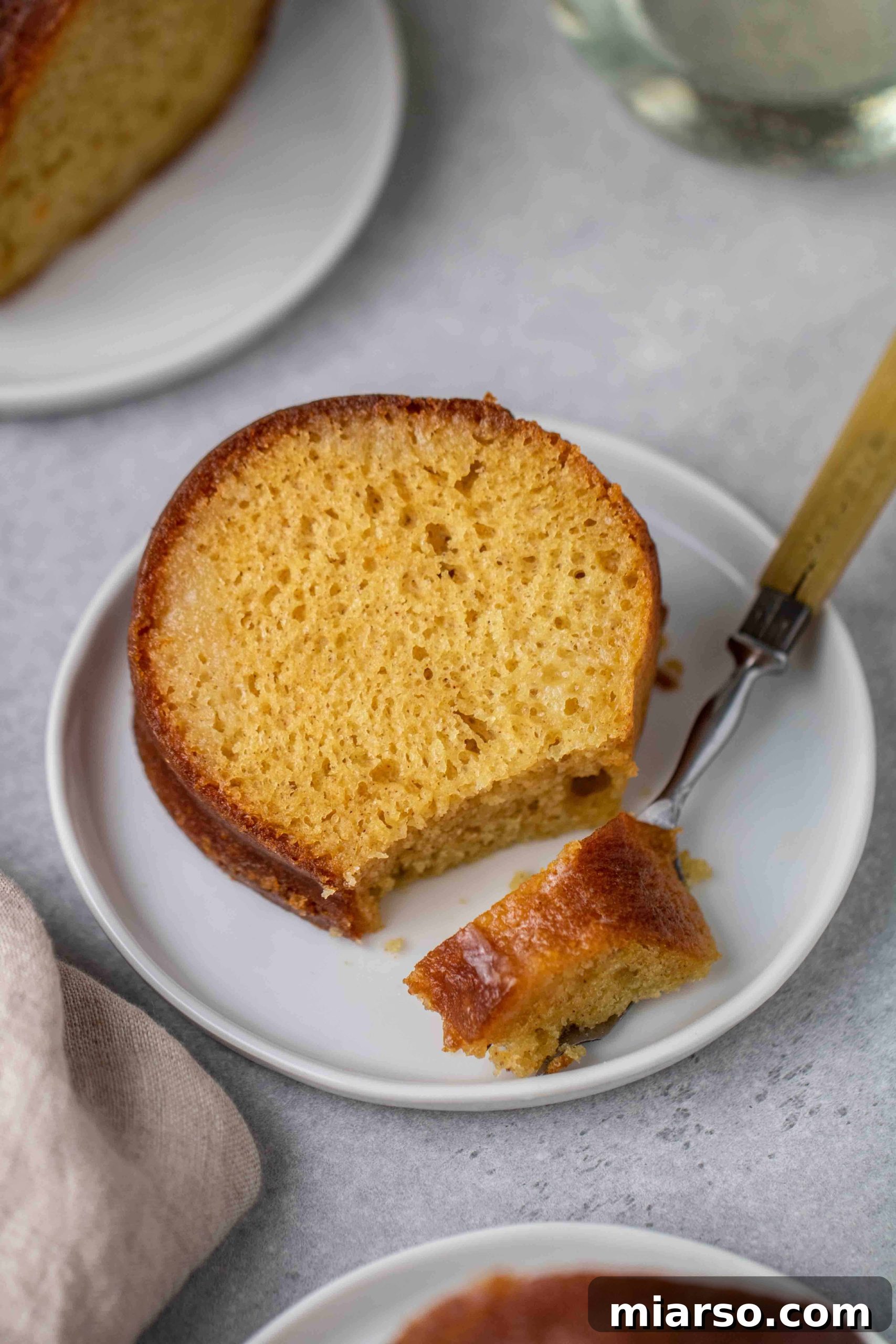 Taking a bite of the doctored up yellow cake mix bundt cake, showing its moist interior