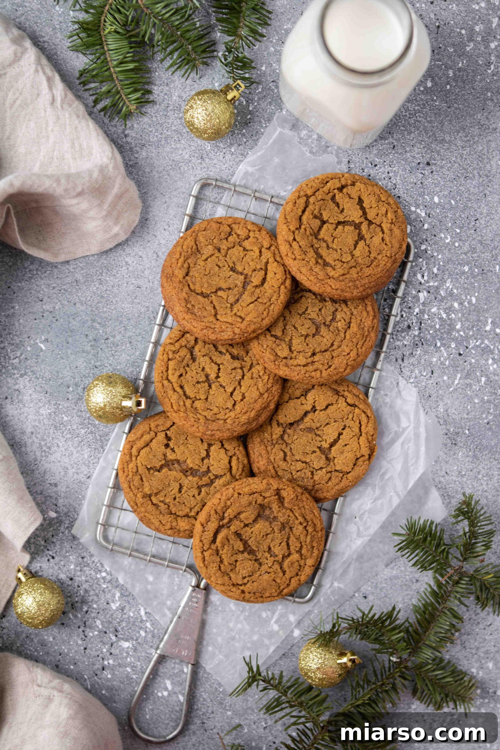 Perfectly Soft and Chewy Ginger Molasses Cookies 3 Overhead photography of perfectly baked, crinkled ginger molasses cookies on a cooling rack.