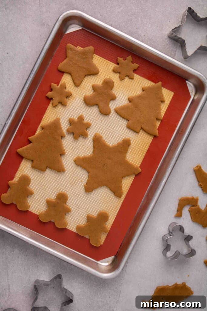 Cutout cookies perfectly placed on a baking sheet
