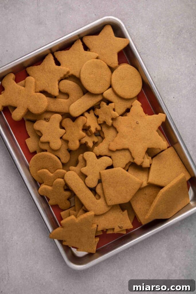 Perfectly baked cutout gingerbread cookies on a cooling rack