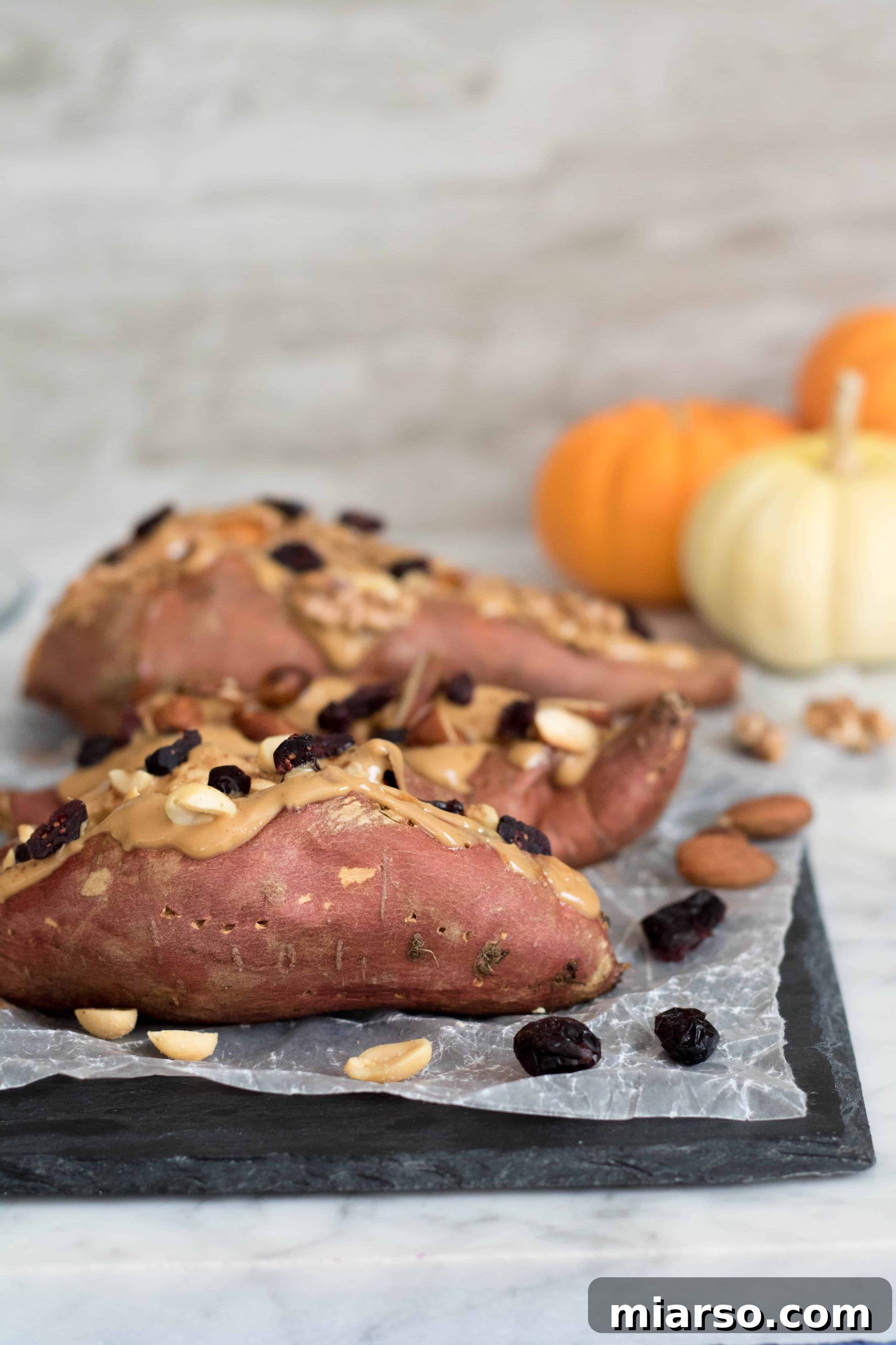 A beautifully presented fall stuffed sweet potato recipe, captured from an overhead angle, highlighting its vibrant toppings.