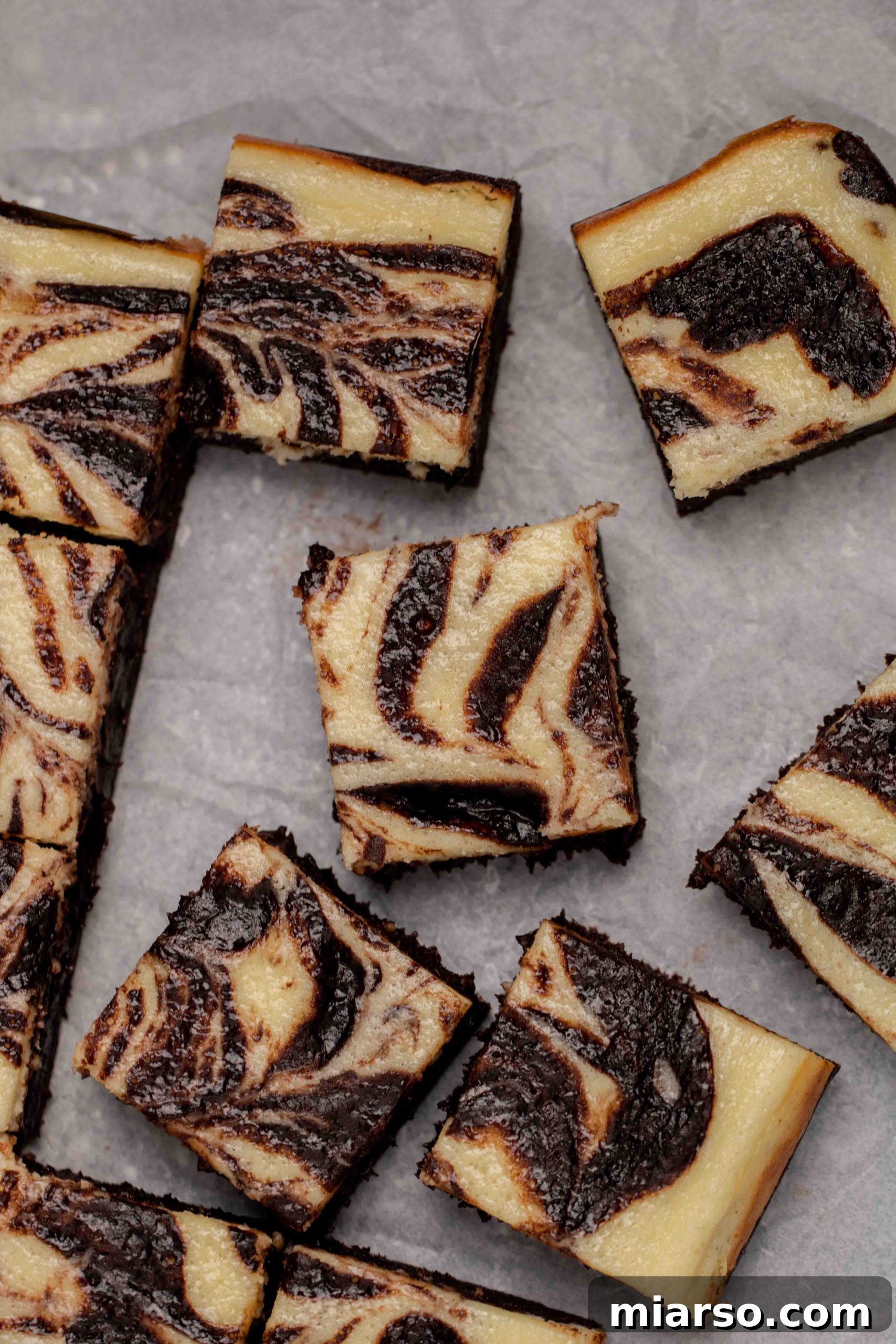 Close-up of a stack of cream cheese brownies, showcasing their soft and chewy texture