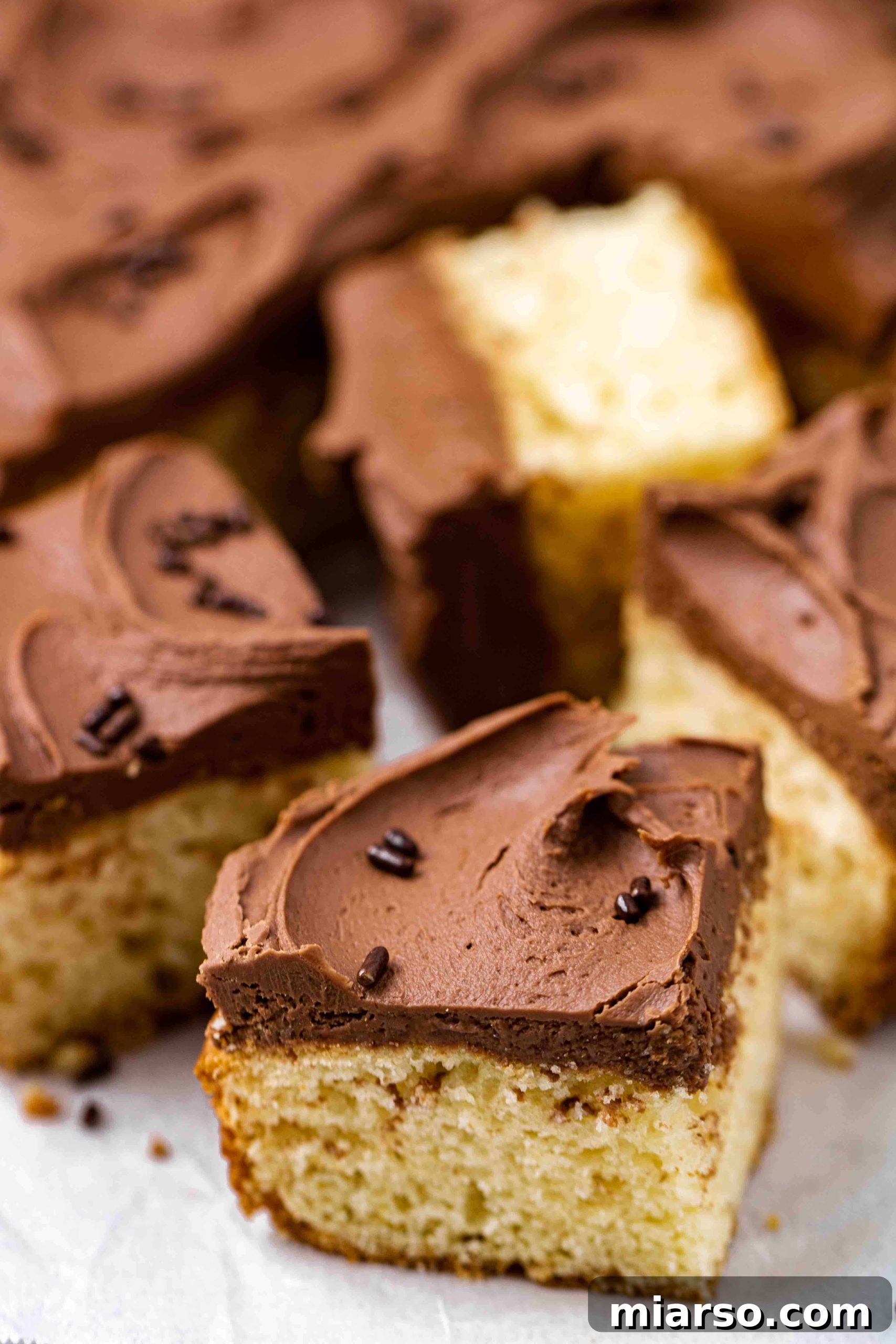 A beautiful slice of vanilla pancake mix cake with a generous layer of frosting.