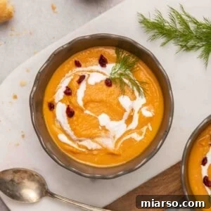 Overhead view of creamy sweet potato soup with garnish