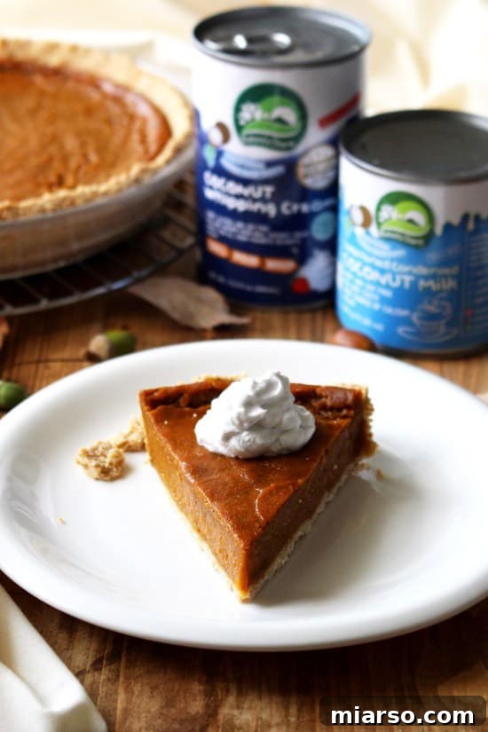 Vegan pumpkin pie with a dollop of coconut cream