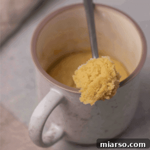 A close-up of the delicious soft and chewy mug sugar cookie on a spoon, showing its inviting texture.