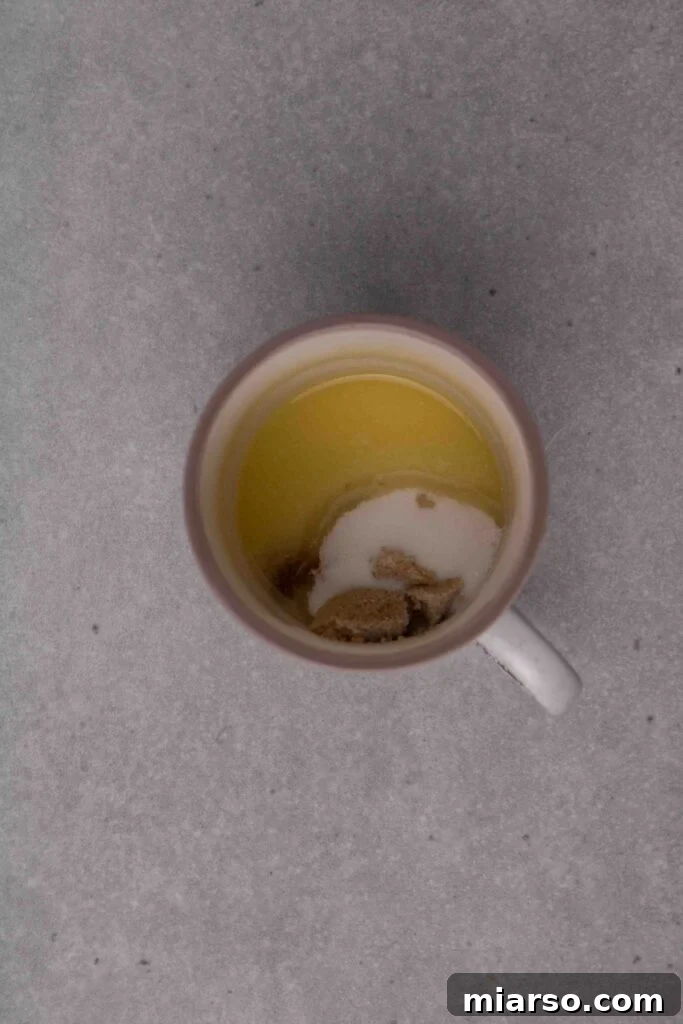 Pillowy Soft Mug Sugar Cookie Perfection 6 Adding sugar to the melted butter in the mug.