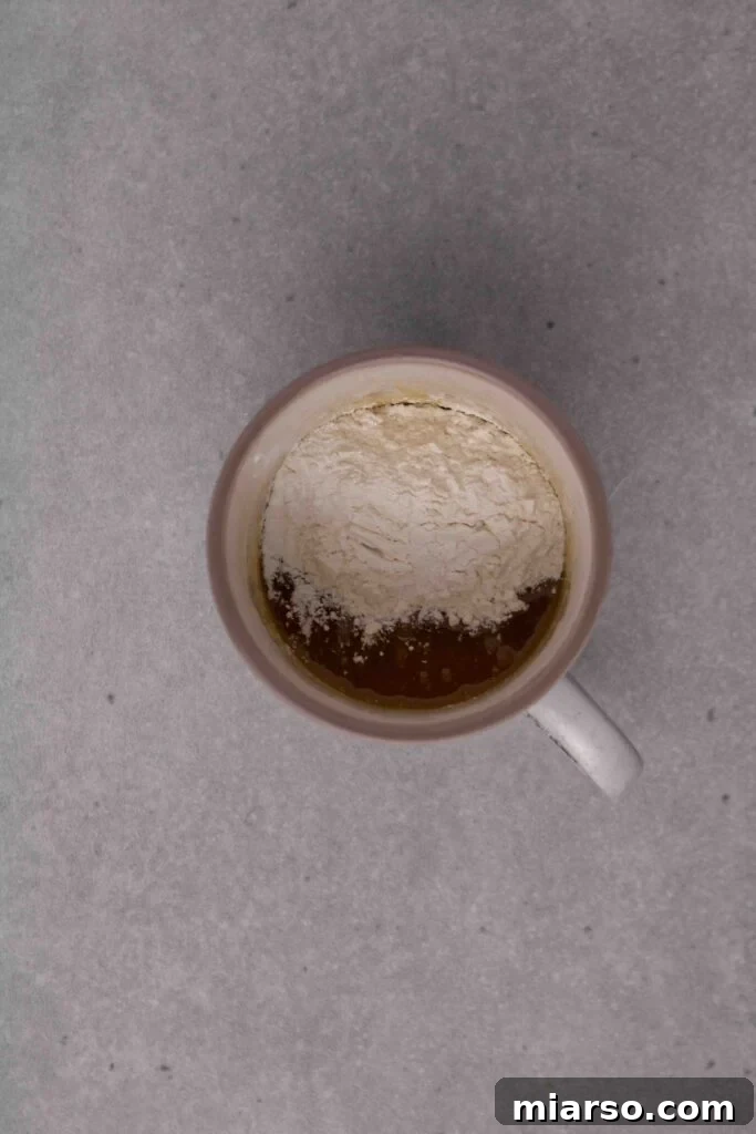 Pillowy Soft Mug Sugar Cookie Perfection 8 Adding flour and corn starch to the mug cookie dough.