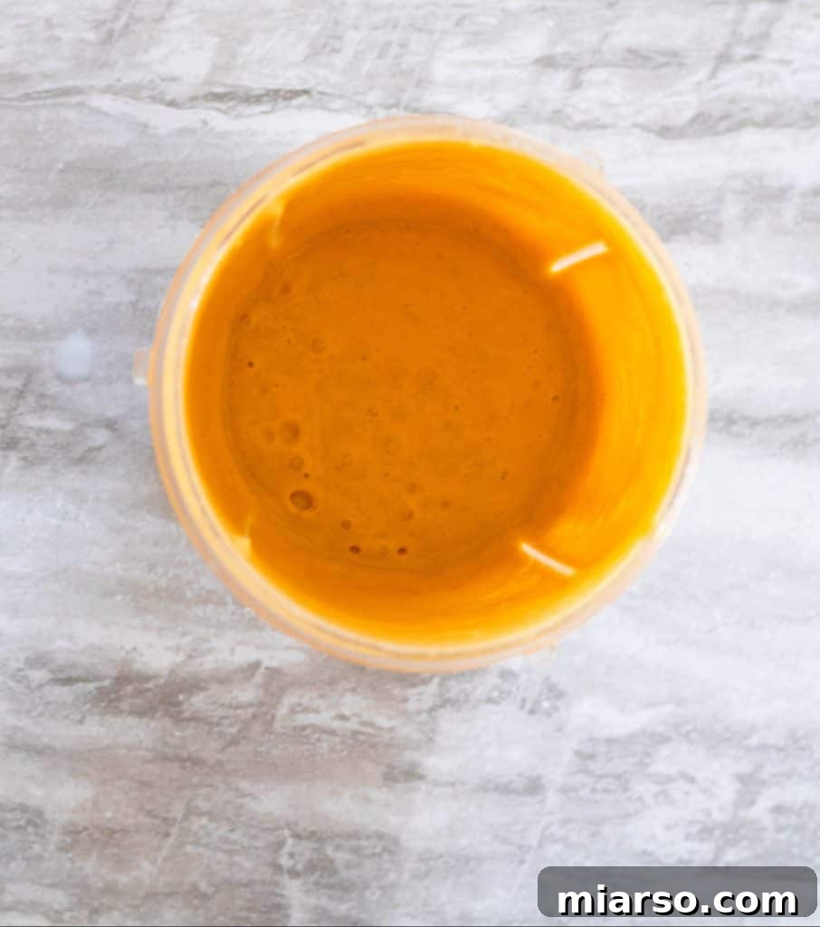 Blending sweet potato smoothie in a high-speed blender