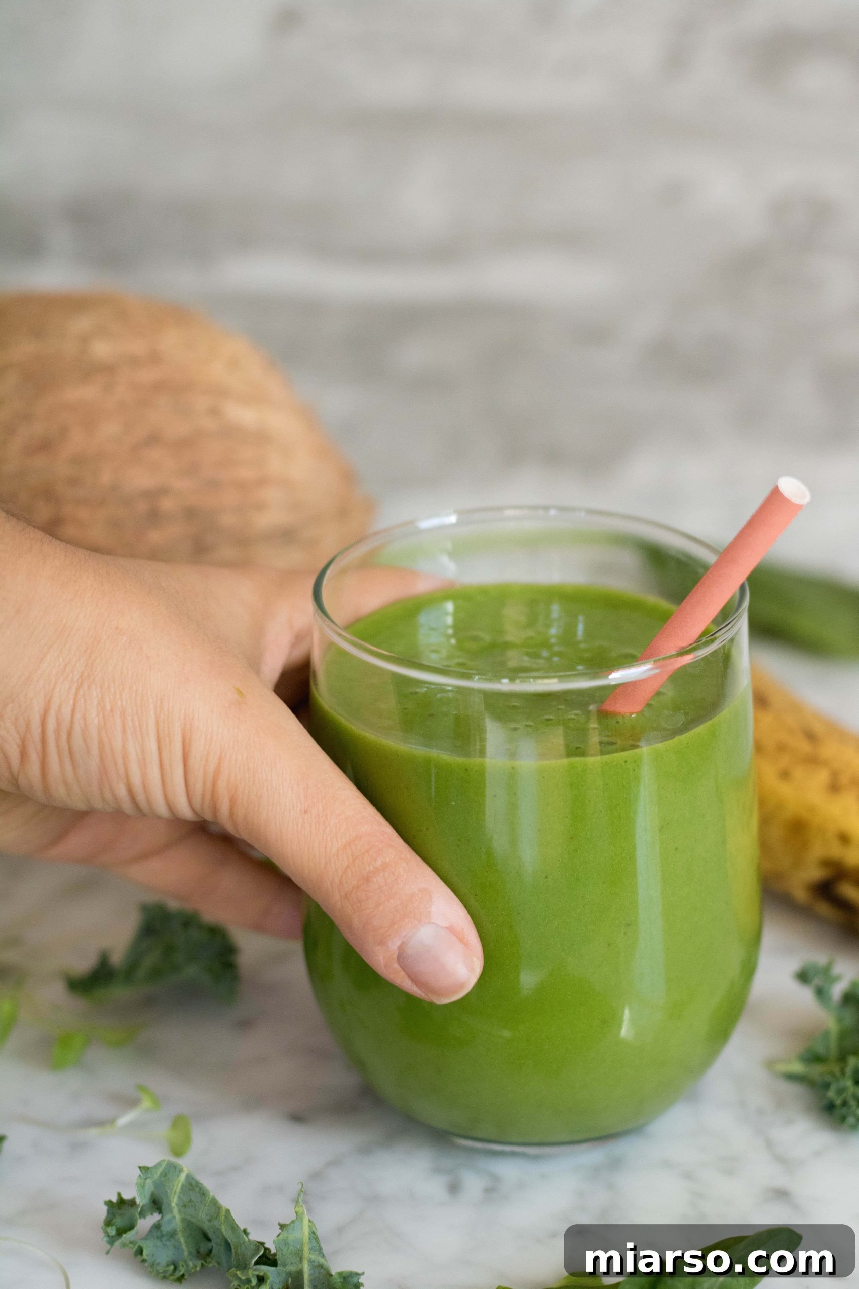 Vibrant green Spinach and Kale smoothie in a glass for a healthy breakfast