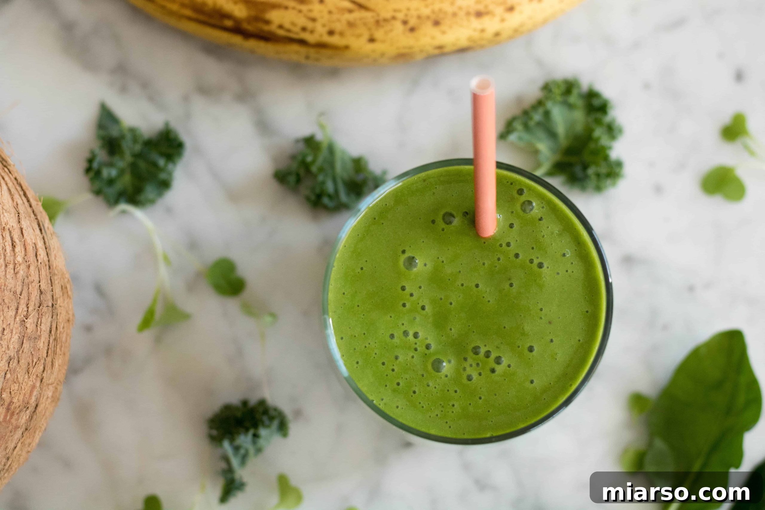 Overhead shot of a vibrant green Spinach and Kale smoothie, fresh and healthy ingredients