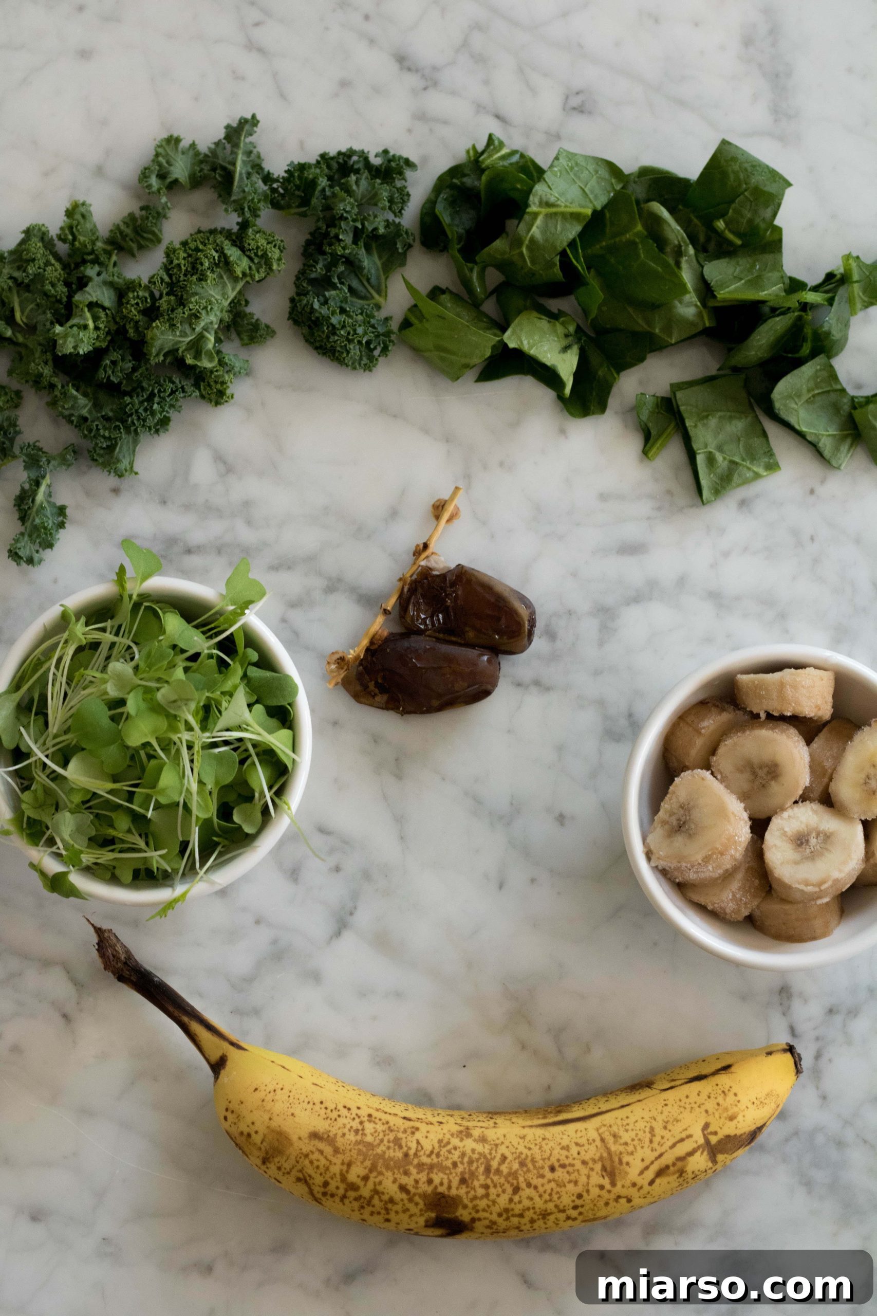 Fresh ingredients laid out for the Kale and Spinach Smoothie recipe, ready for blending