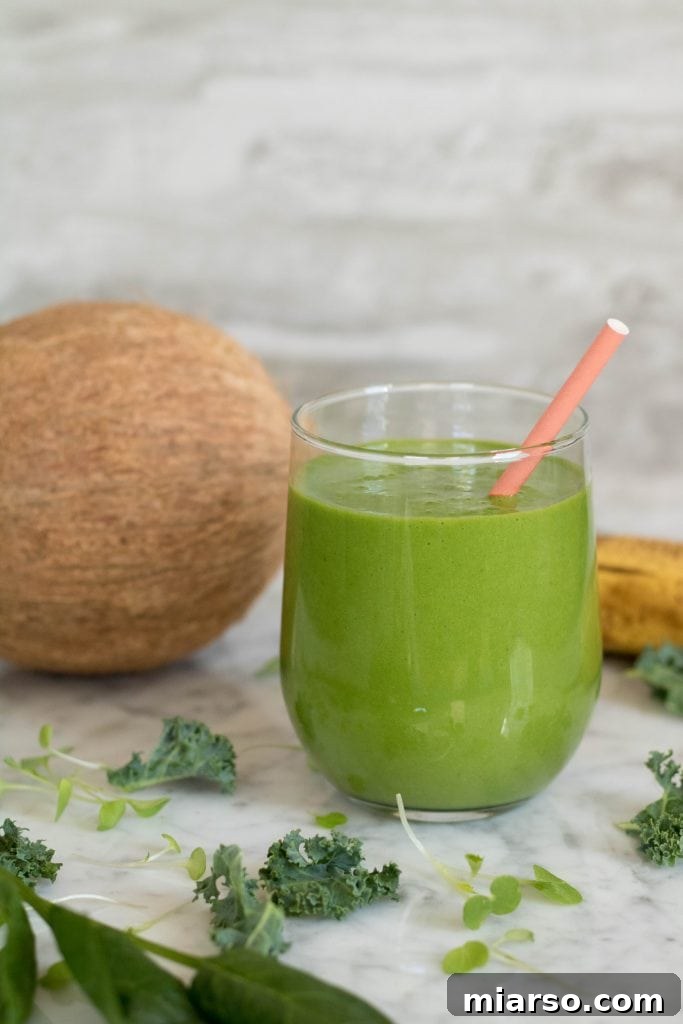 Kale and Spinach Smoothie photo with a fresh coconut in the background, a refreshing drink