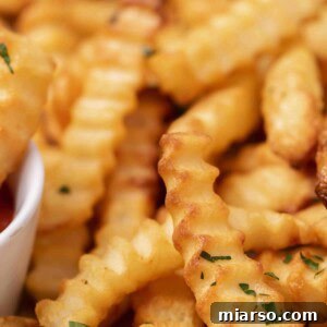 Close up of crunchy air fryer frozen crinkle fries