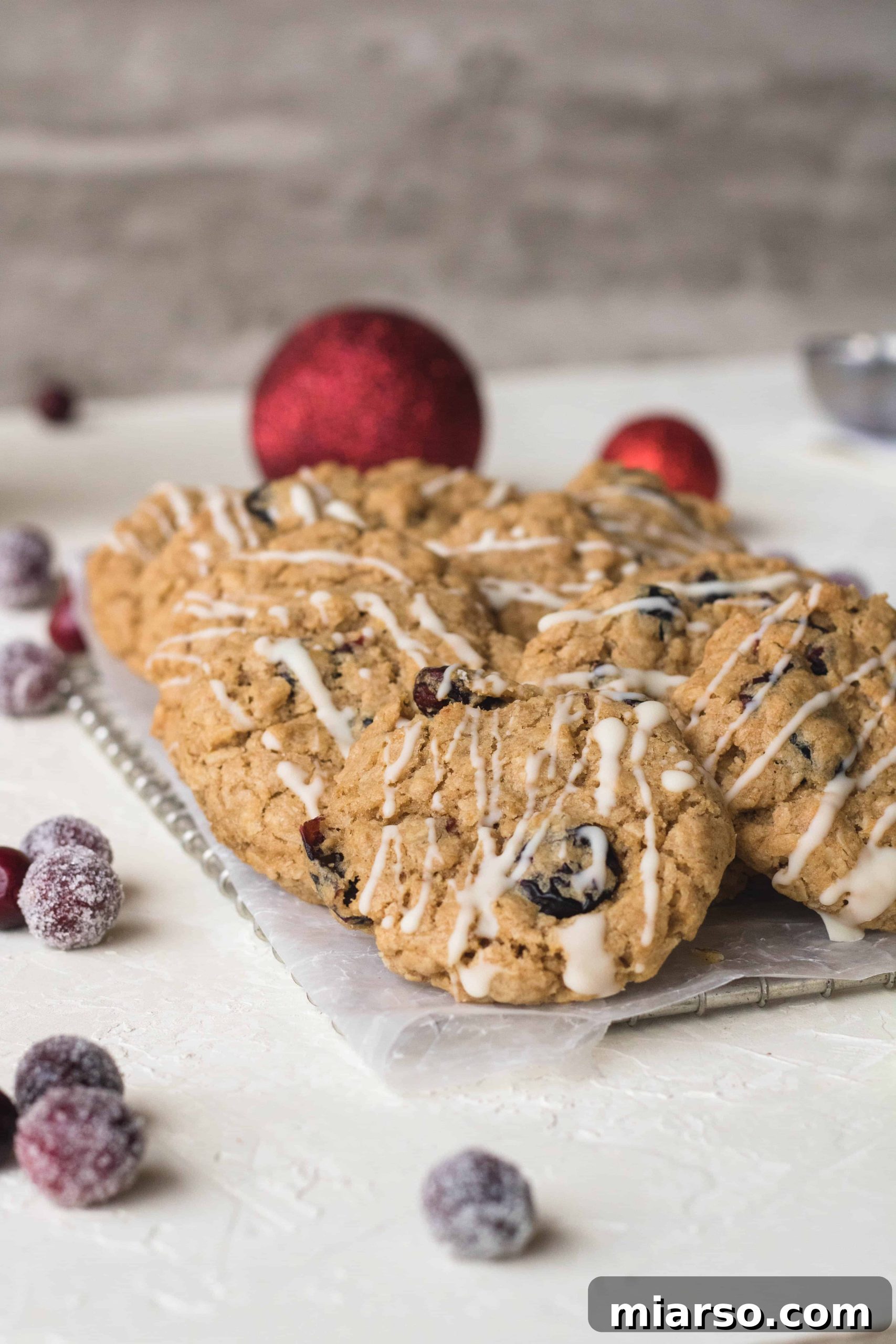Cranberry oatmeal cookies with a delicate white chocolate drizzle, ready for the holidays