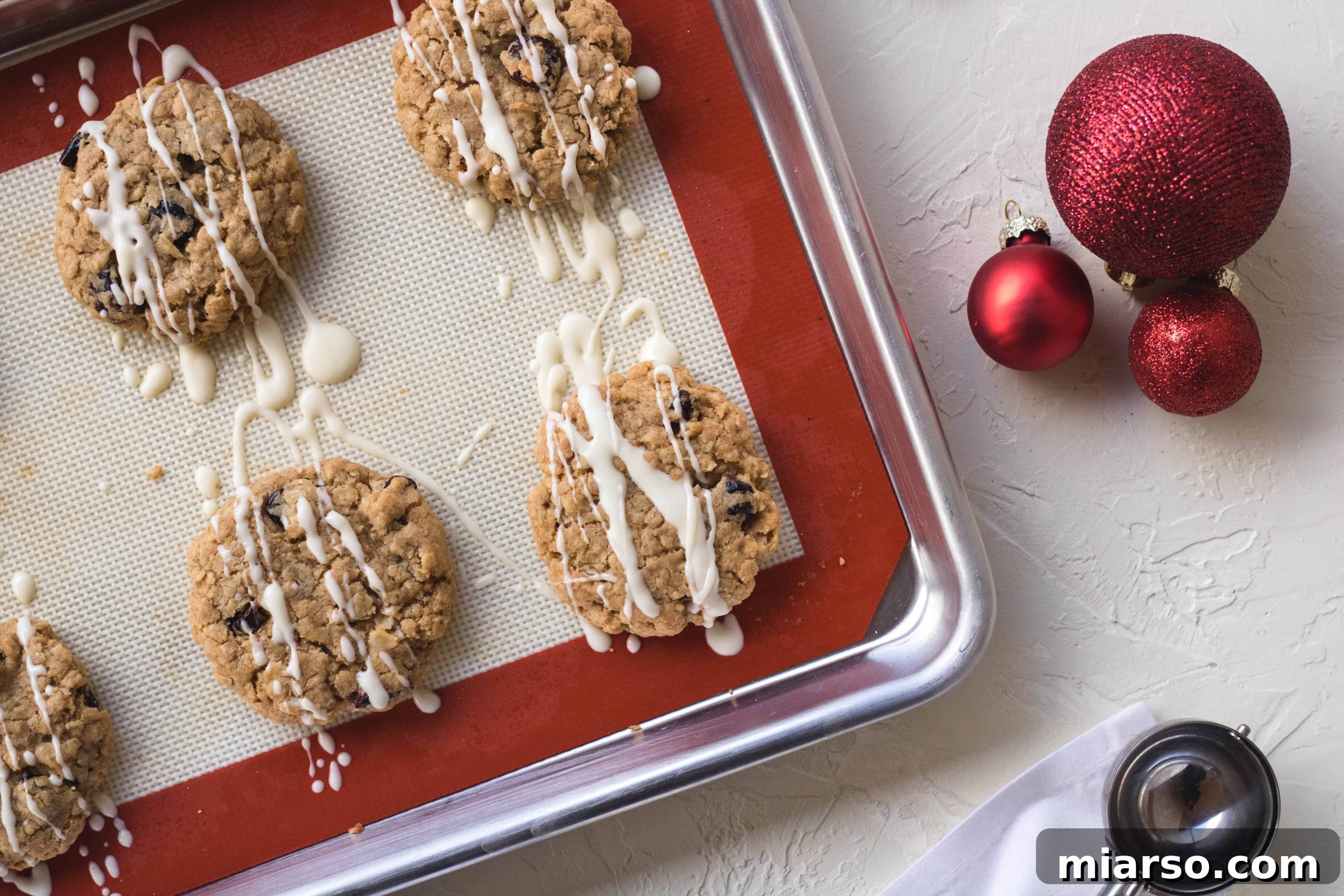 Close-up of baked cranberry oatmeal cookies, beautifully adorned with white chocolate