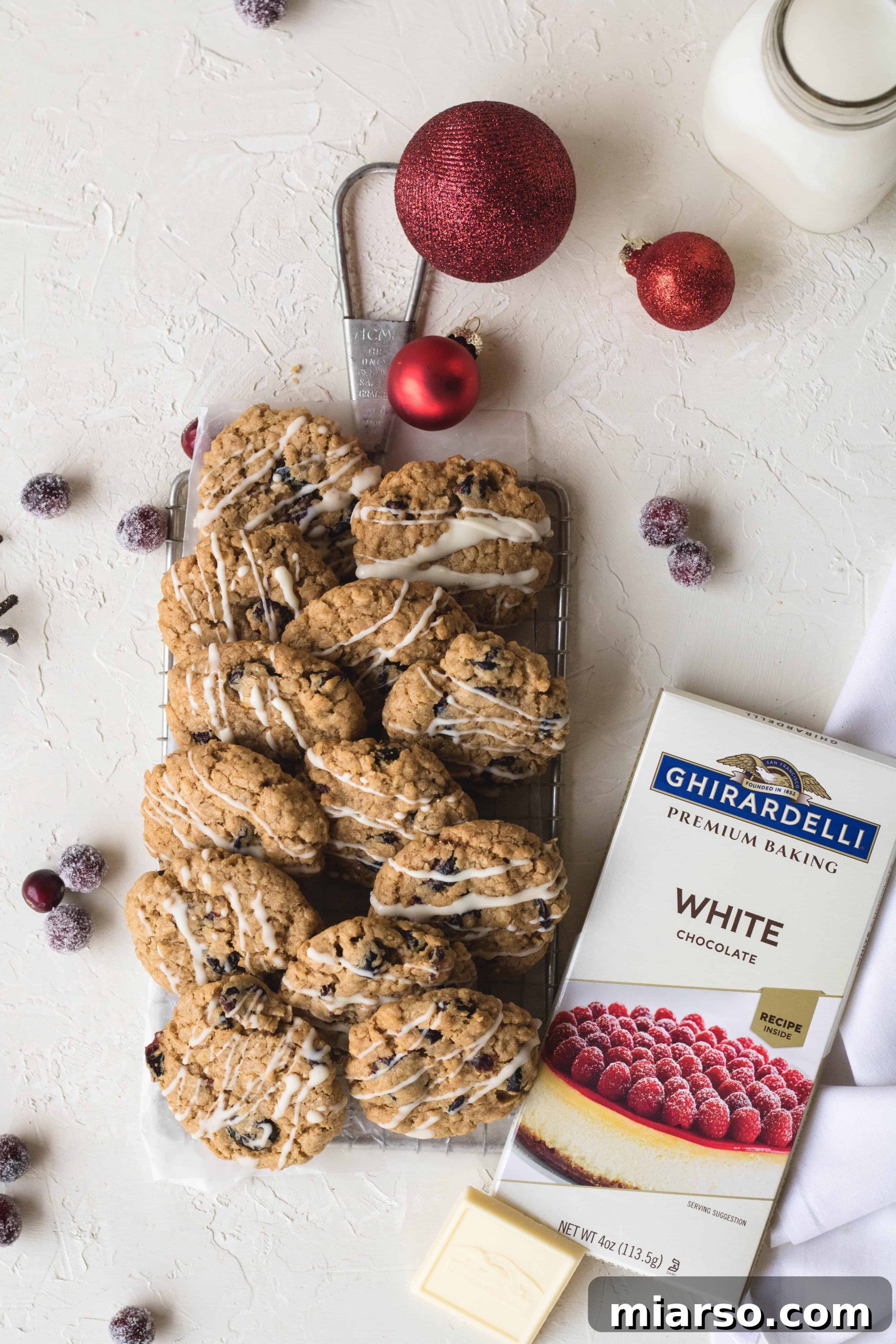 Festive oatmeal and cranberry cookies with a luscious Ghirardelli white chocolate drizzle on top