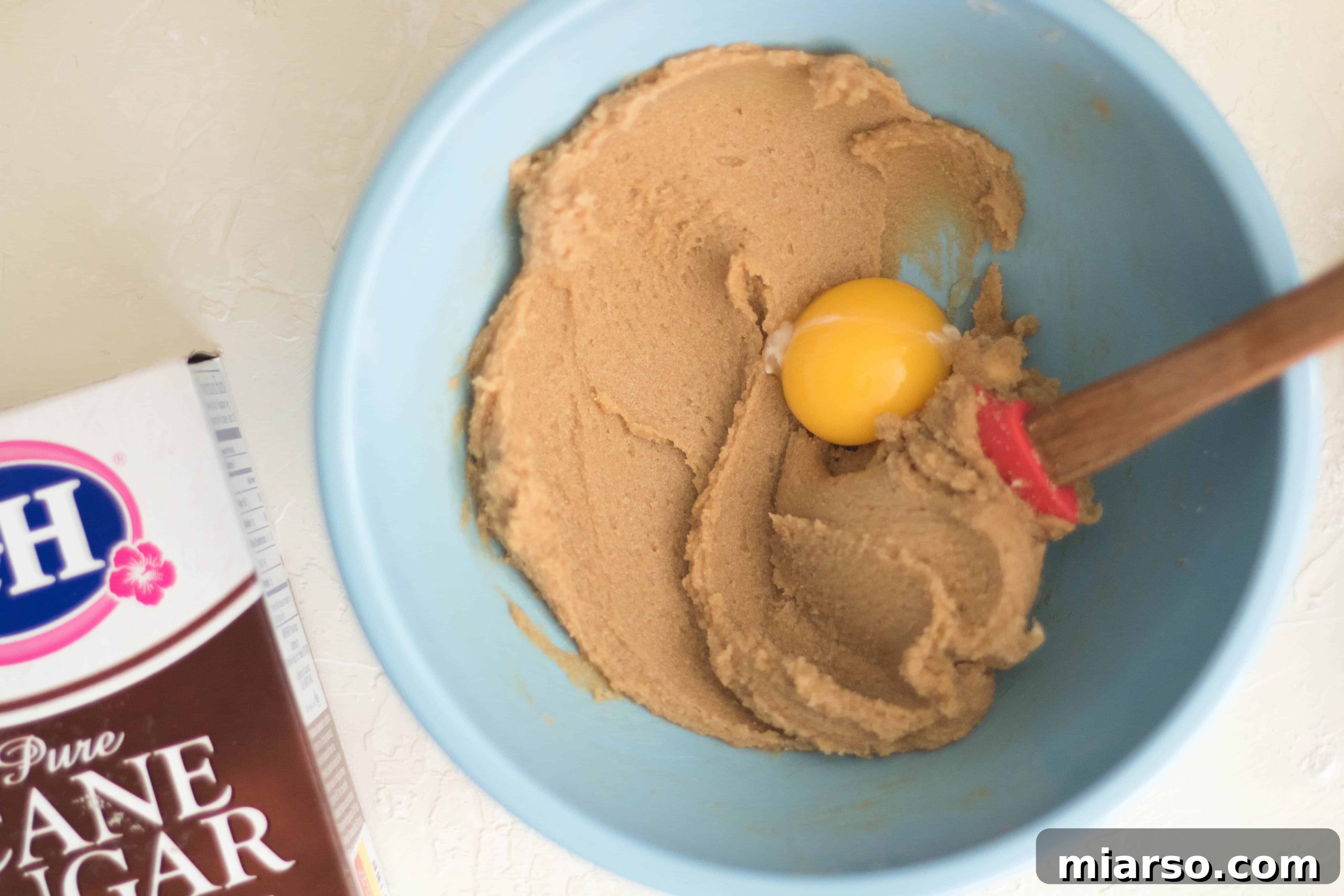 Step-by-step image of creaming butter and sugars for chocolate chip cookies.