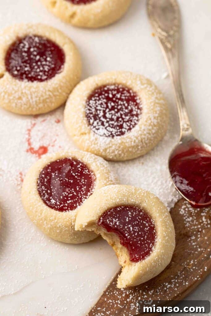 Jam-Kissed Almond Thumbprint Cookies 2 Delicious strawberry thumbprint cookies with a spoonful of glistening jam