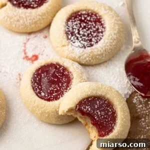 Strawberry thumbprint cookies, perfectly golden with a rich jam center.