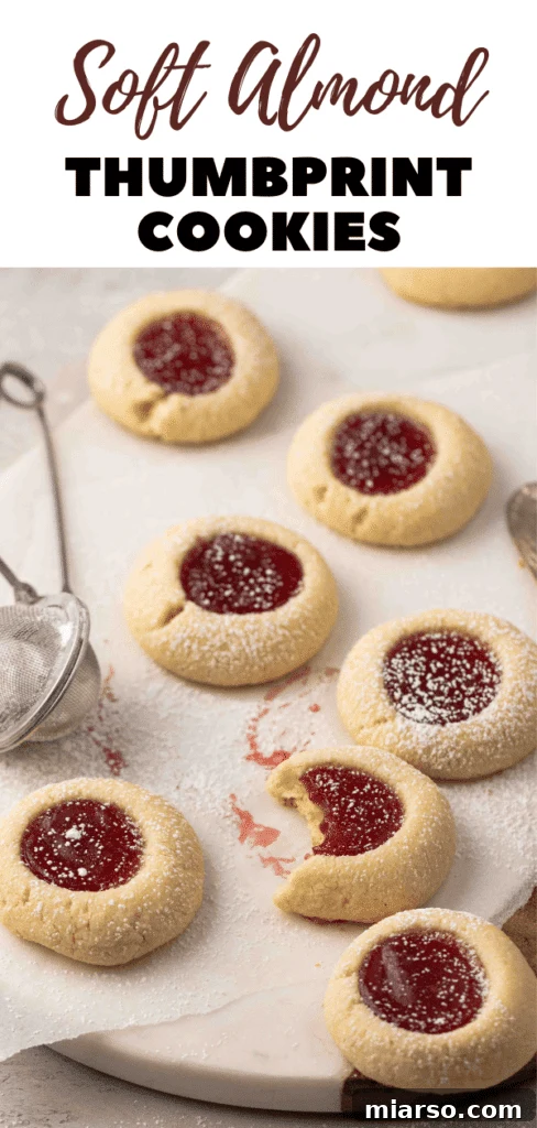 Jam-Kissed Almond Thumbprint Cookies 22 An artistic shot of almond flour thumbprint cookies with glistening jam