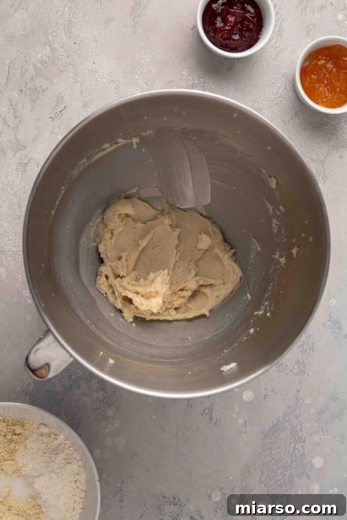 Jam-Kissed Almond Thumbprint Cookies 7 Step 1: Creaming butter with sugar until light and fluffy.