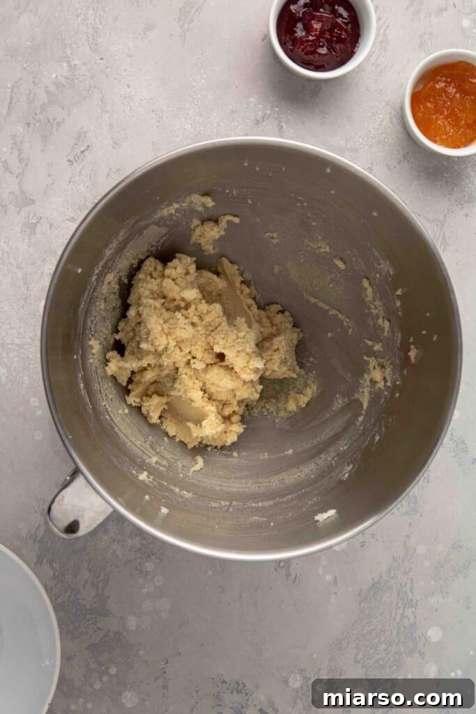 Jam-Kissed Almond Thumbprint Cookies 9 Step 3: Mixing to form a cohesive almond flour cookie dough.