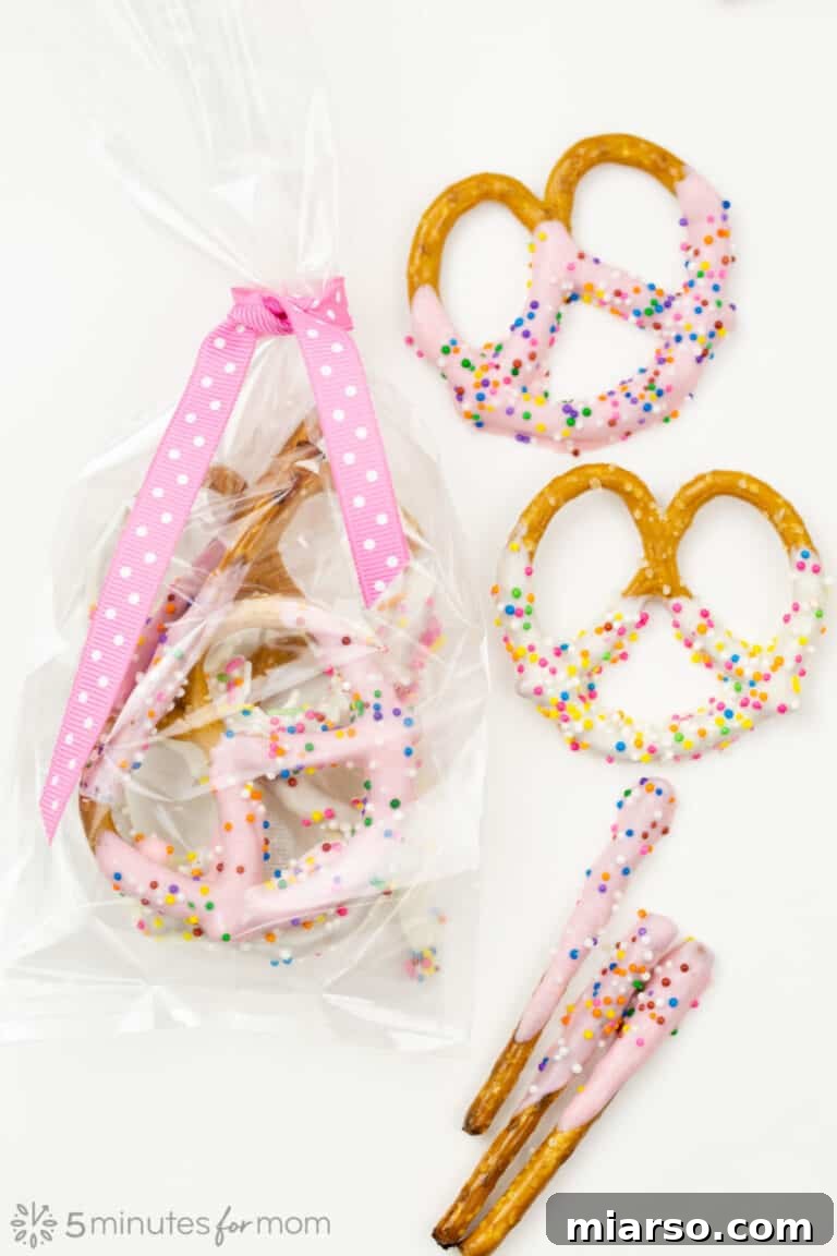 18 Heartfelt No-Bake Valentine Treats Kids Will Adore 12 Chocolate-dipped Valentine's Day pretzels, adorned with pink and red sprinkles and a drizzle of white chocolate.