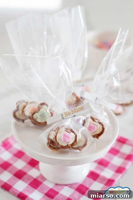 18 Heartfelt No-Bake Valentine Treats Kids Will Adore 17 Valentine's Day pretzel hearts, decorated with conversation heart candies.