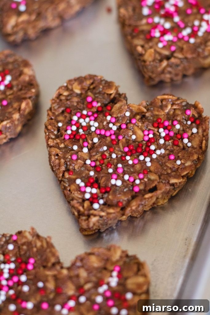 18 Heartfelt No-Bake Valentine Treats Kids Will Adore 3 Healthy No Bake Cookies for Valentine's Day, shaped like hearts and decorated with sprinkles.