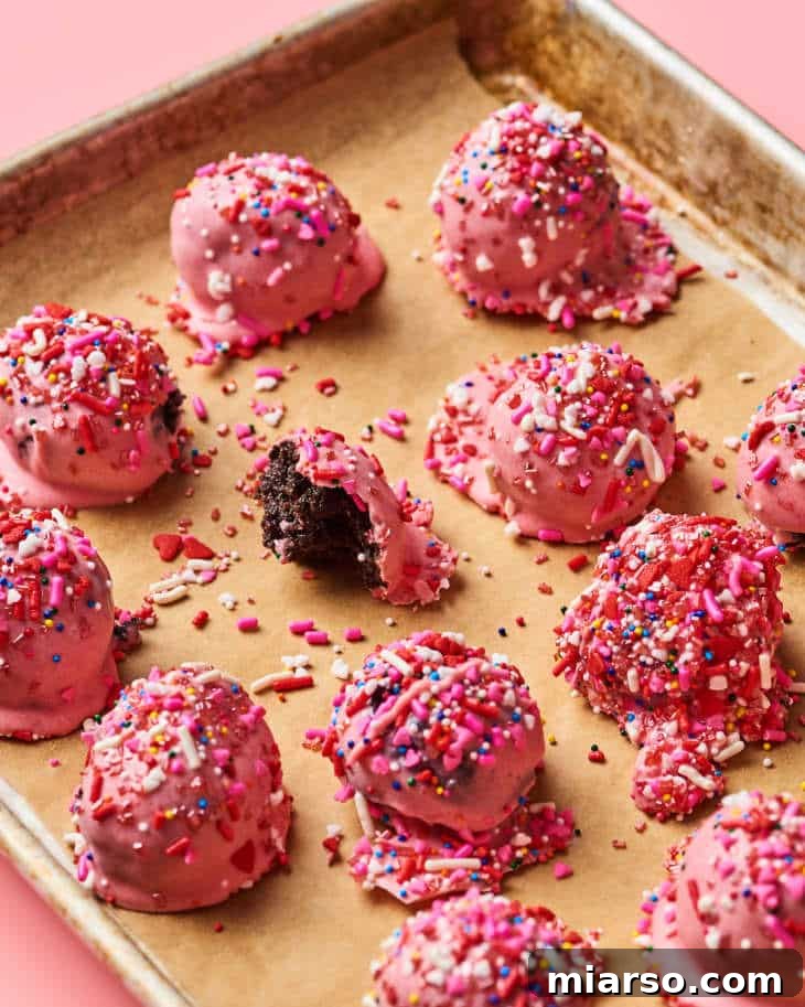 18 Heartfelt No-Bake Valentine Treats Kids Will Adore 7 Pink Valentine's Day Oreo truffles, delicately decorated with sprinkles and ribbons, perfect for gifting.