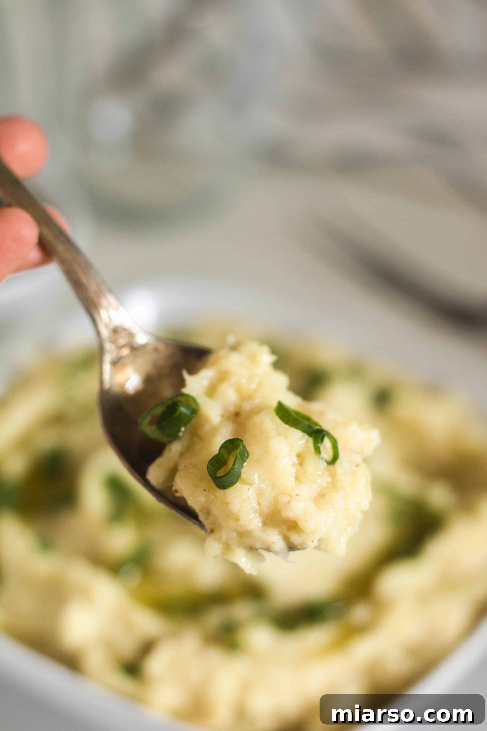 Brown Butter Garlic Mashed Sweet Potatoes, garnished with fresh herbs, ready to serve.
