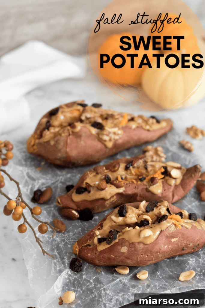 Two halves of fall-stuffed sweet potatoes, garnished with fresh herbs.