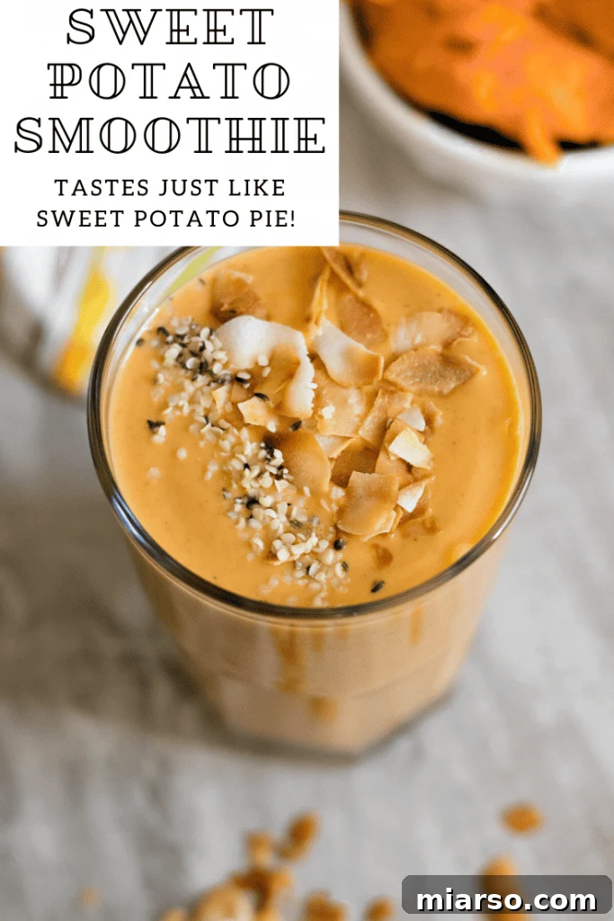 A tall glass of healthy sweet potato smoothie, garnished with a cinnamon stick.