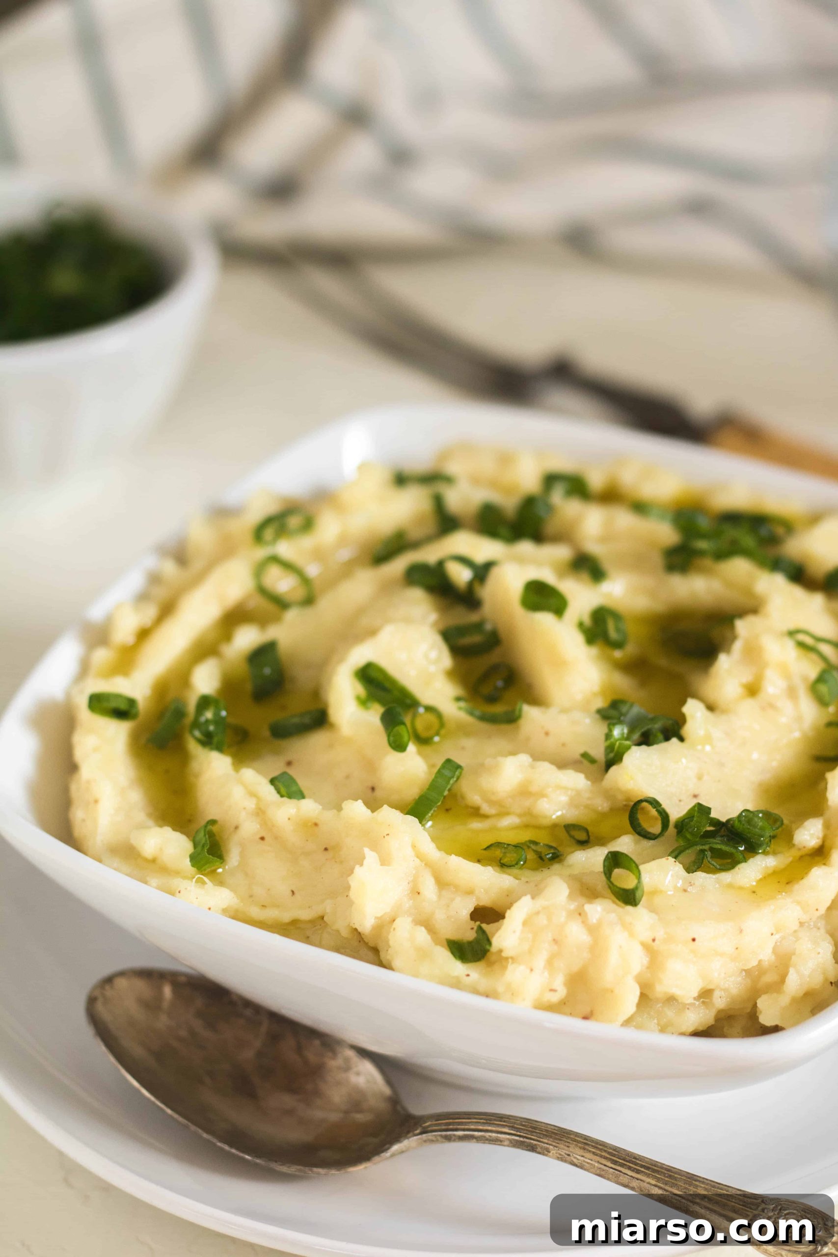 Close-up of brown butter garlic savory sweet potato mash in a serving bowl.