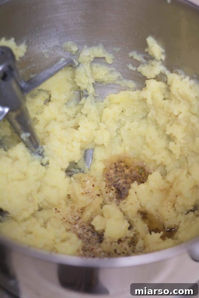 Draining cooked white yams after boiling.