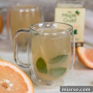 Beautifully garnished warm detox grapefruit tea in a mug, ready to drink