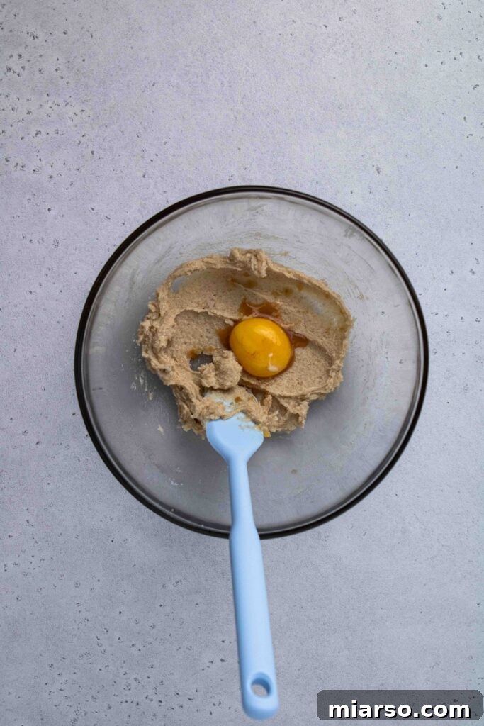 Add egg yolk to creamed butter